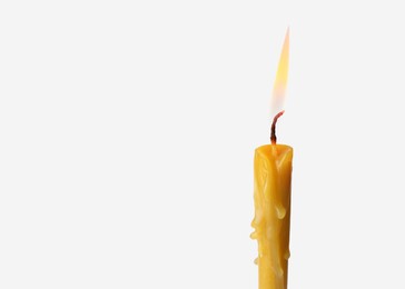 Image of Burning church candle on light background. Space for text