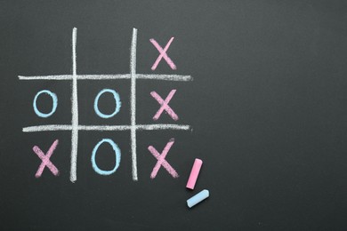 Photo of Tic tac toe game drawn on chalkboard, top view
