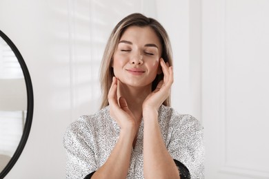 Portrait of beautiful young woman in room