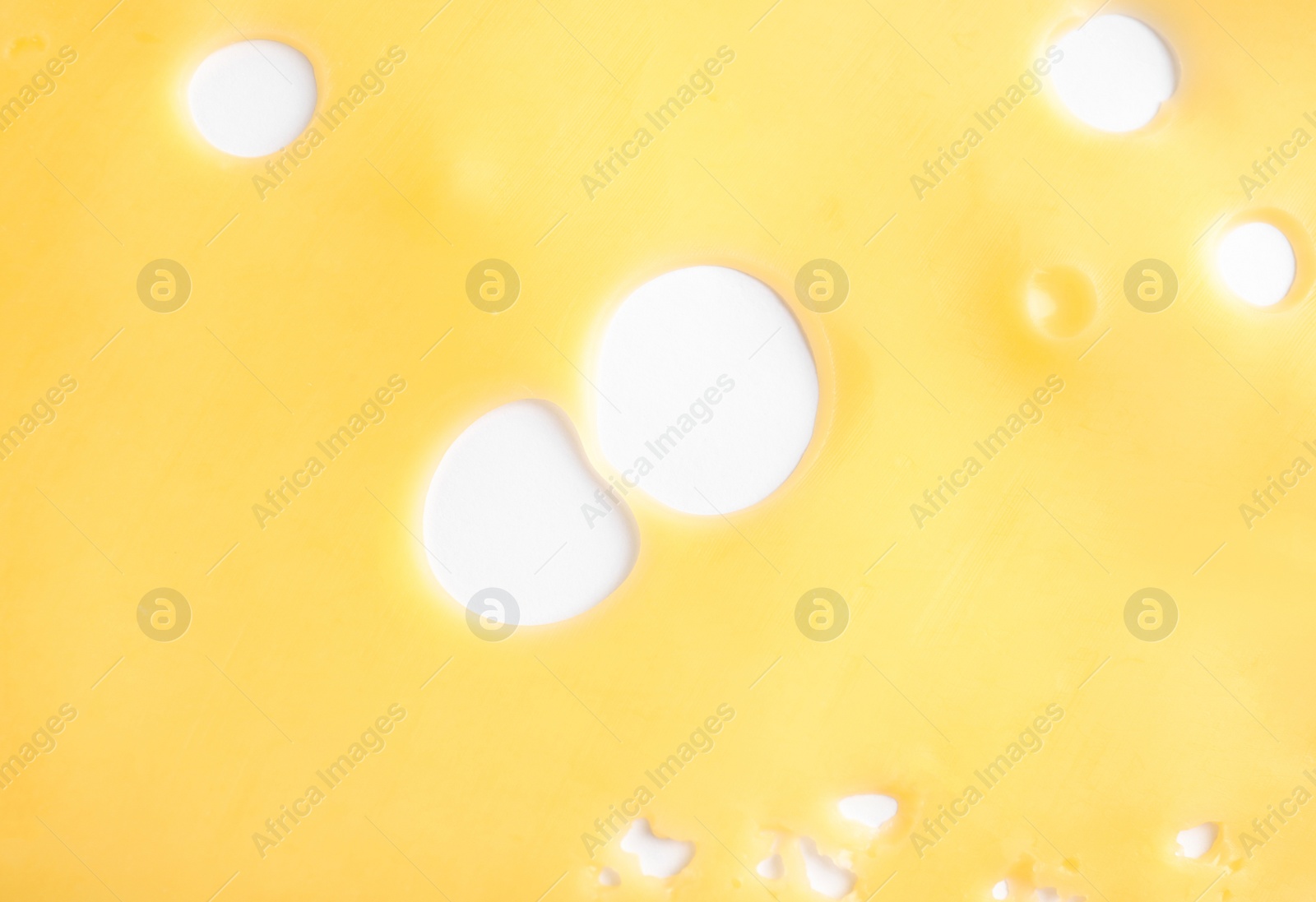 Photo of Slice of tasty maasdam cheese on white background, top view