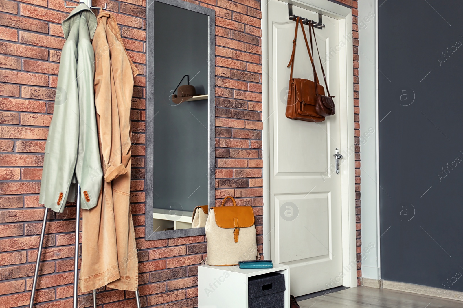 Photo of Stylish hallway interior with mirror and hanger stand