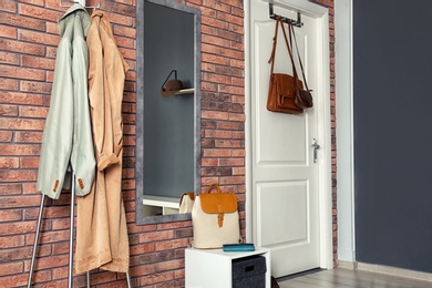 Photo of Stylish hallway interior with mirror and hanger stand