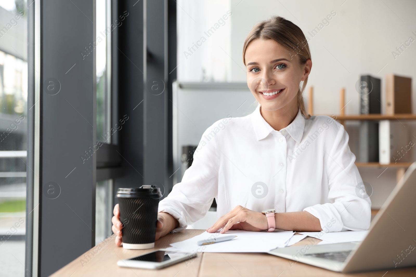 Photo of Female business trainer working with laptop in office