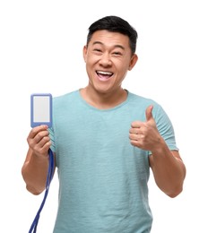 Photo of Happy asian man with vip pass badge showing thumbs up on white background