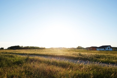 Photo of Picturesque view of countryside with houses in field