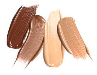 Image of Foundation of various shades for different skin tones isolated on white, top view. Set of samples