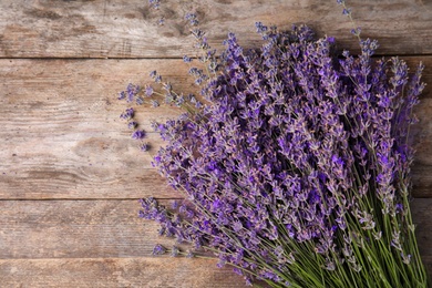 Photo of Lavender flowers on wooden background, top view