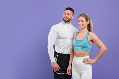 Portrait of happy athletic people on purple background, space for text