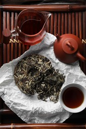 Flat lay composition with pu-erh tea on wooden tray. Traditional ceremony