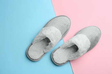 Pair of soft slippers on color background, flat lay