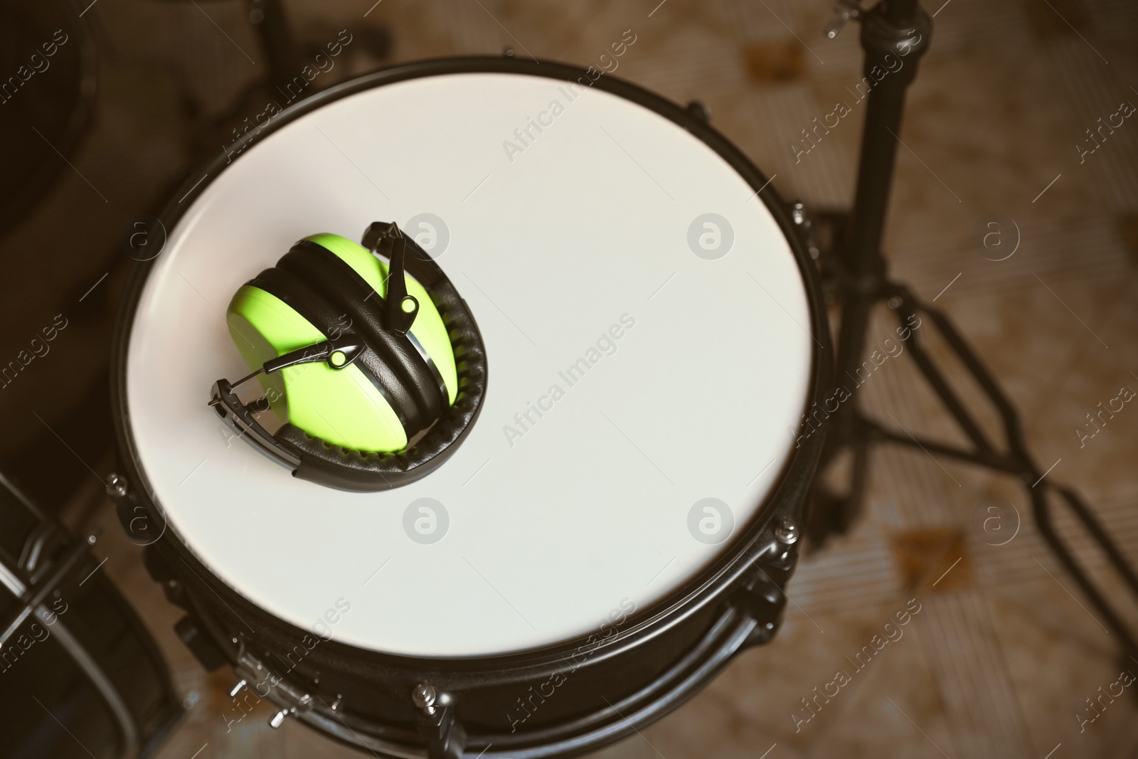 Photo of Above view of modern drum and headphones in studio