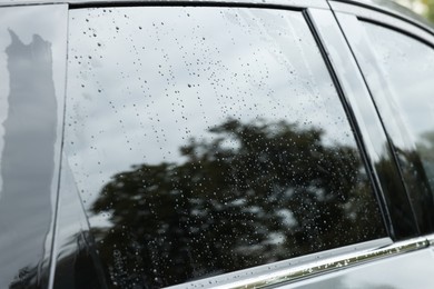 Photo of Drops of water on car window glass, closeup