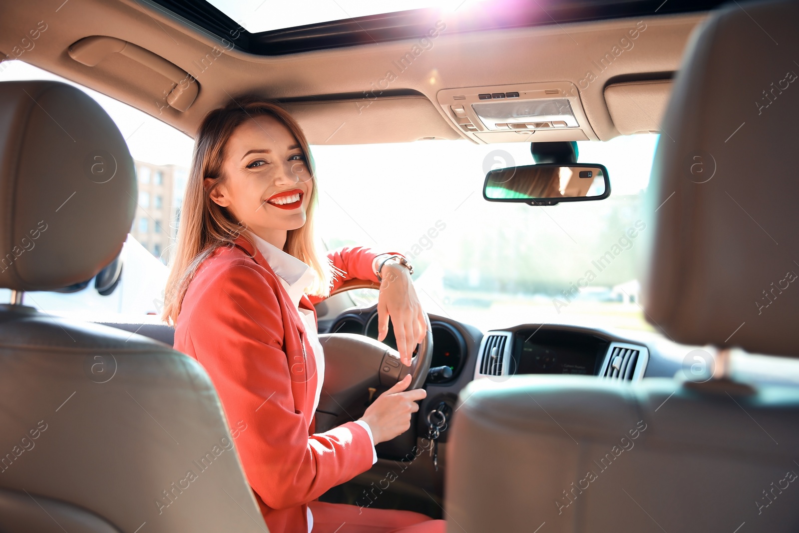 Photo of Young businesswoman on driver's seat of car