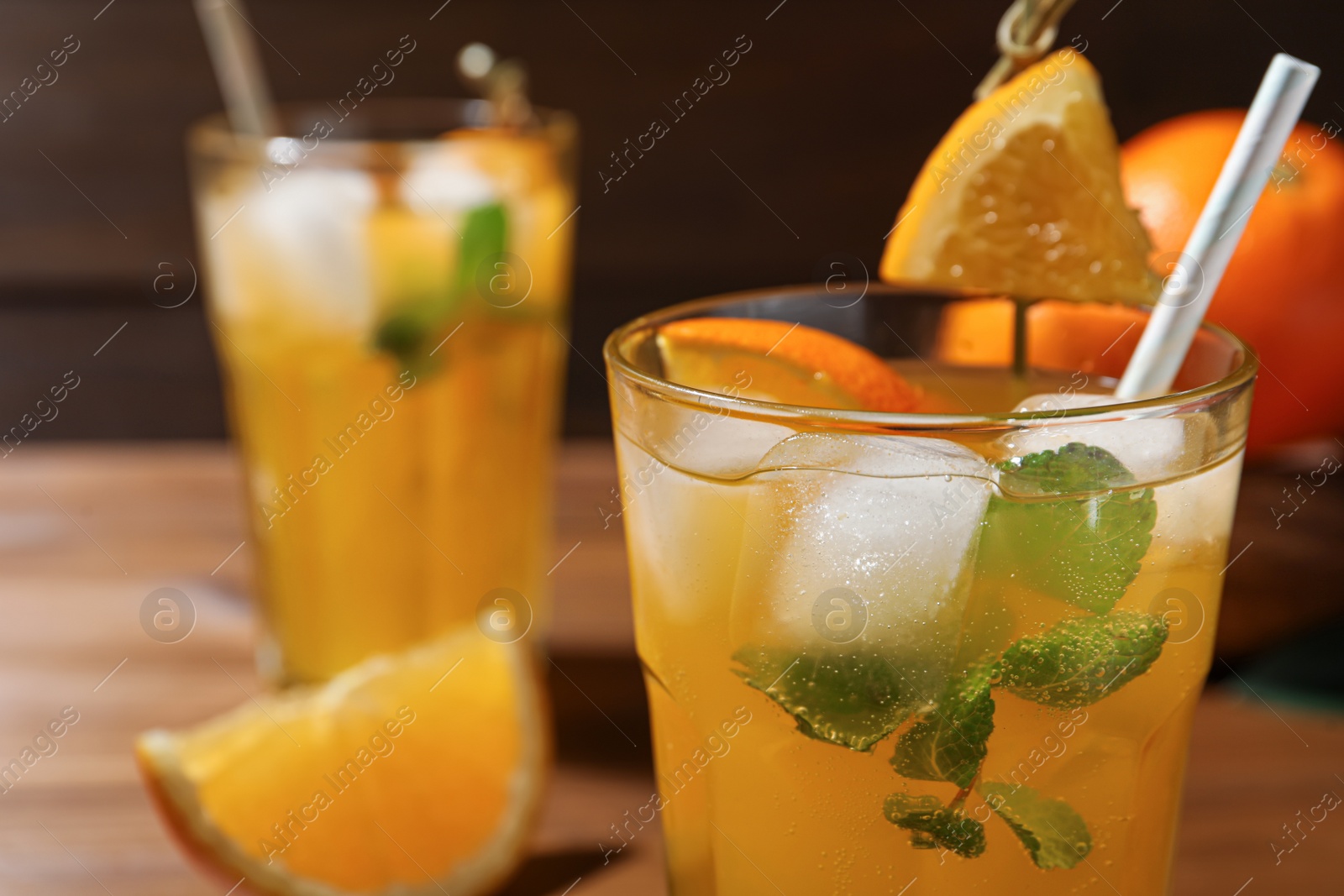 Photo of Delicious orange soda water in glass, closeup