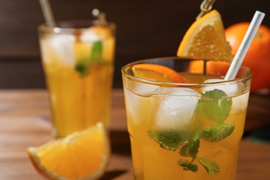 Photo of Delicious orange soda water in glass, closeup