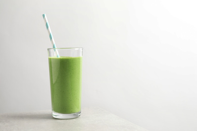 Tasty kale smoothie on light grey marble table, space for text