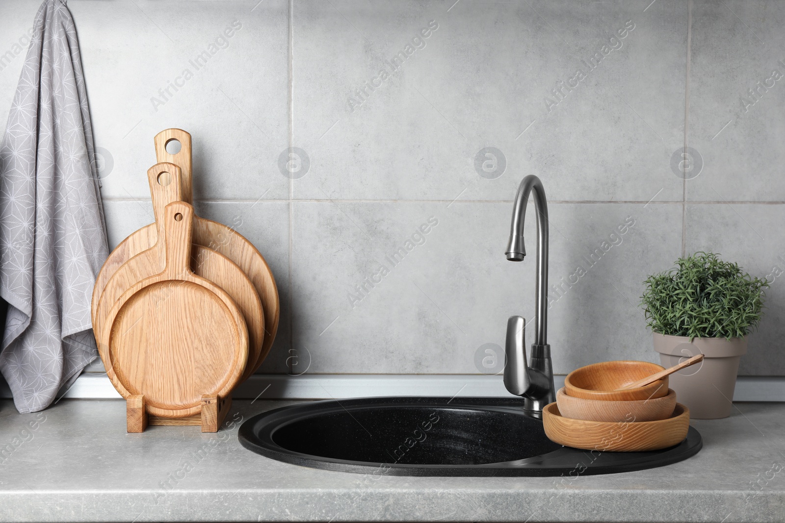 Photo of Wooden cutting boards, dishware and towel in kitchen