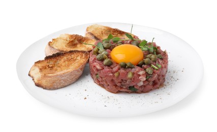 Tasty beef steak tartare served with yolk, capers, toasted bread and greens isolated on white