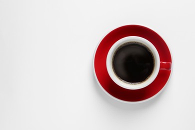 Cup with aromatic coffee on white background, top view. Space for text