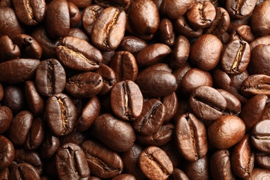 Roasted coffee beans as background, top view