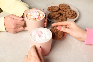 Photo of Women having coffee break at marble table, closeup