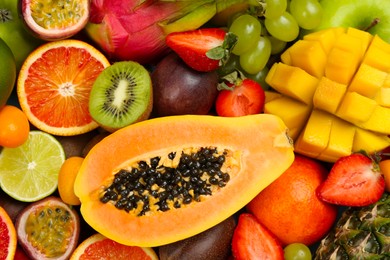 Many different delicious exotic fruits as background, top view