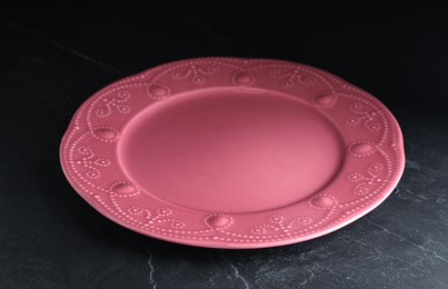 Photo of New clean plate on black slate table