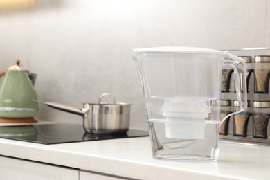 Photo of Water filter jug on white countertop in kitchen