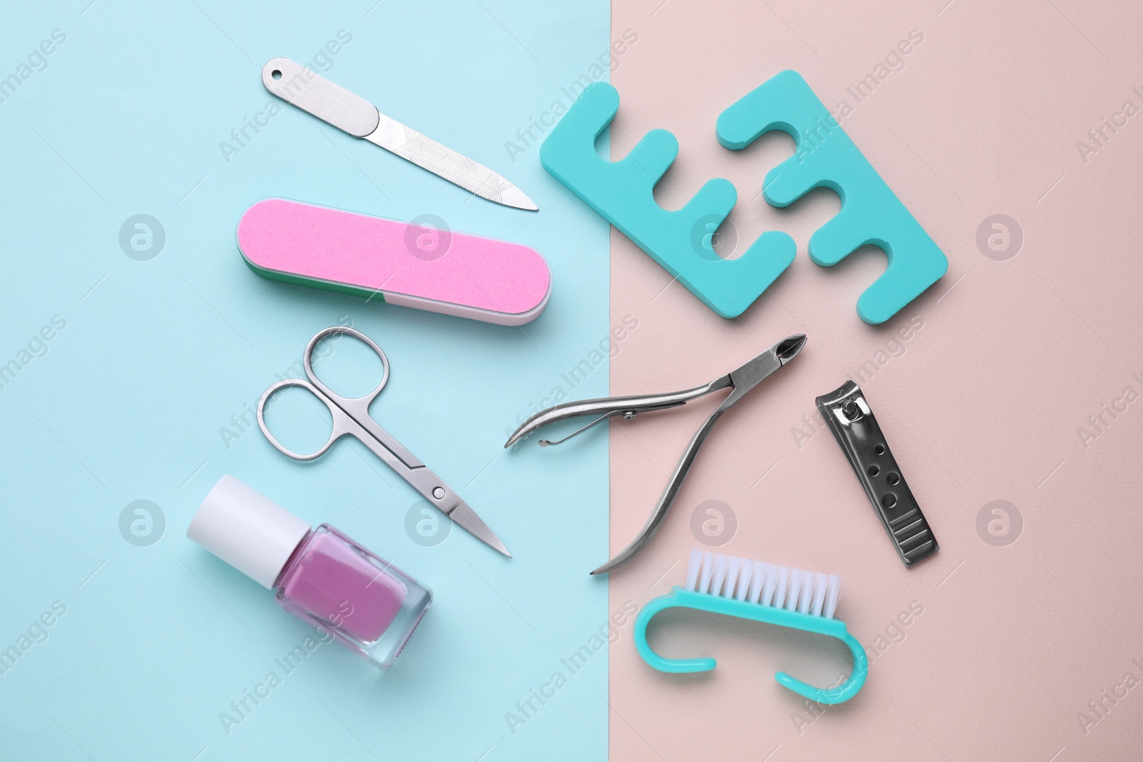 Photo of Set of pedicure tools on color background, flat lay