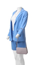 Photo of Female mannequin dressed in light blue suit and top with accessories isolated on white. Stylish outfit