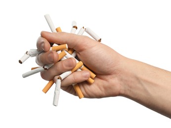 Stop smoking. Man holding broken cigarettes on white background, closeup