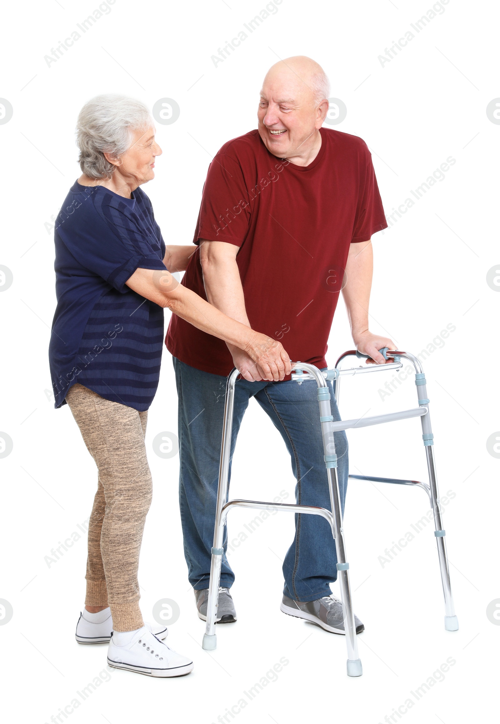 Photo of Elderly woman helping her husband with walking frame on white background