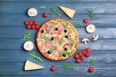 Photo of Composition with delicious pizza and ingredients on wooden background, top view