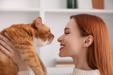 Happy woman with her cute cat at home