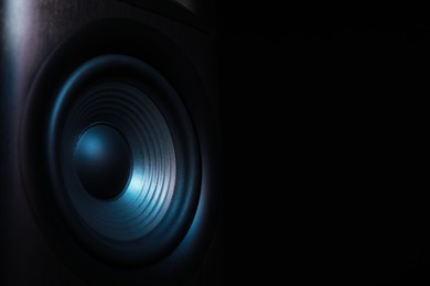 Photo of One sound speaker on black background, closeup. Space for text