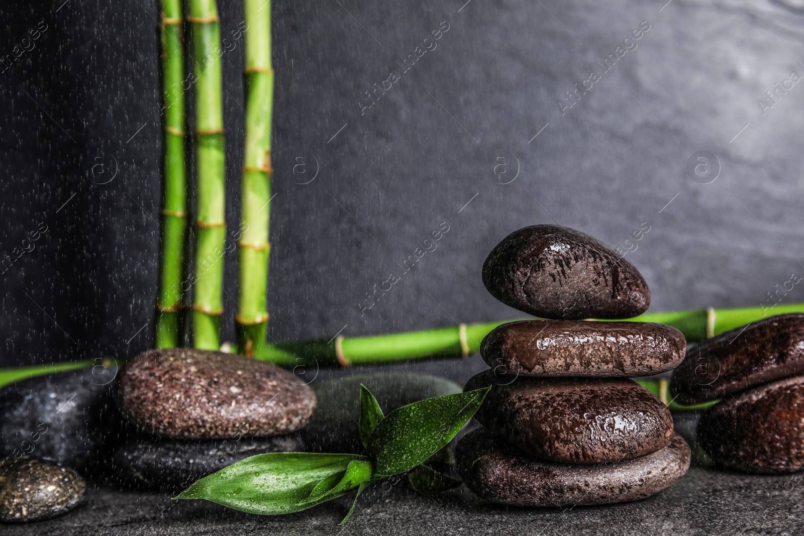 Photo of Composition with stones and bamboo on table. Zen concept