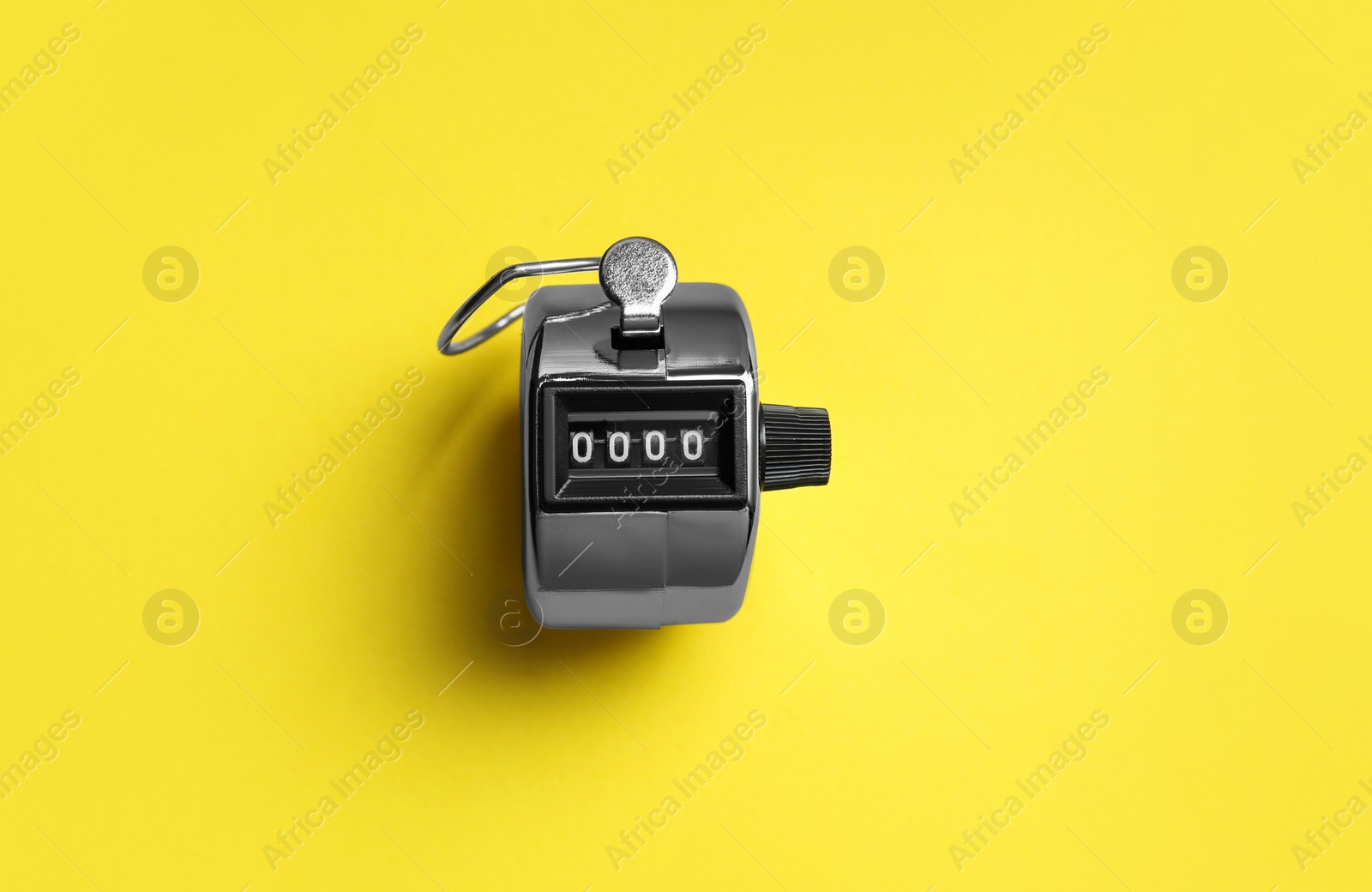 Photo of Modern timer on yellow background, top view