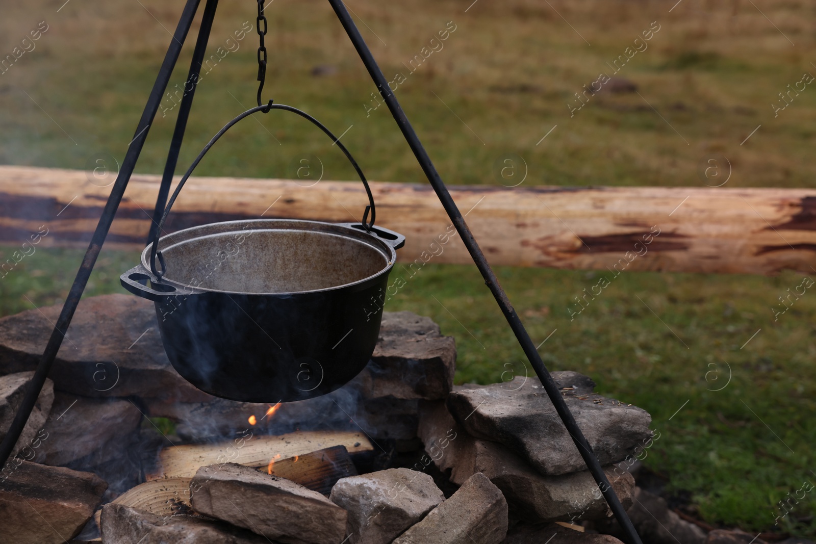 Photo of Cooking food on campfire outdoors. Camping season