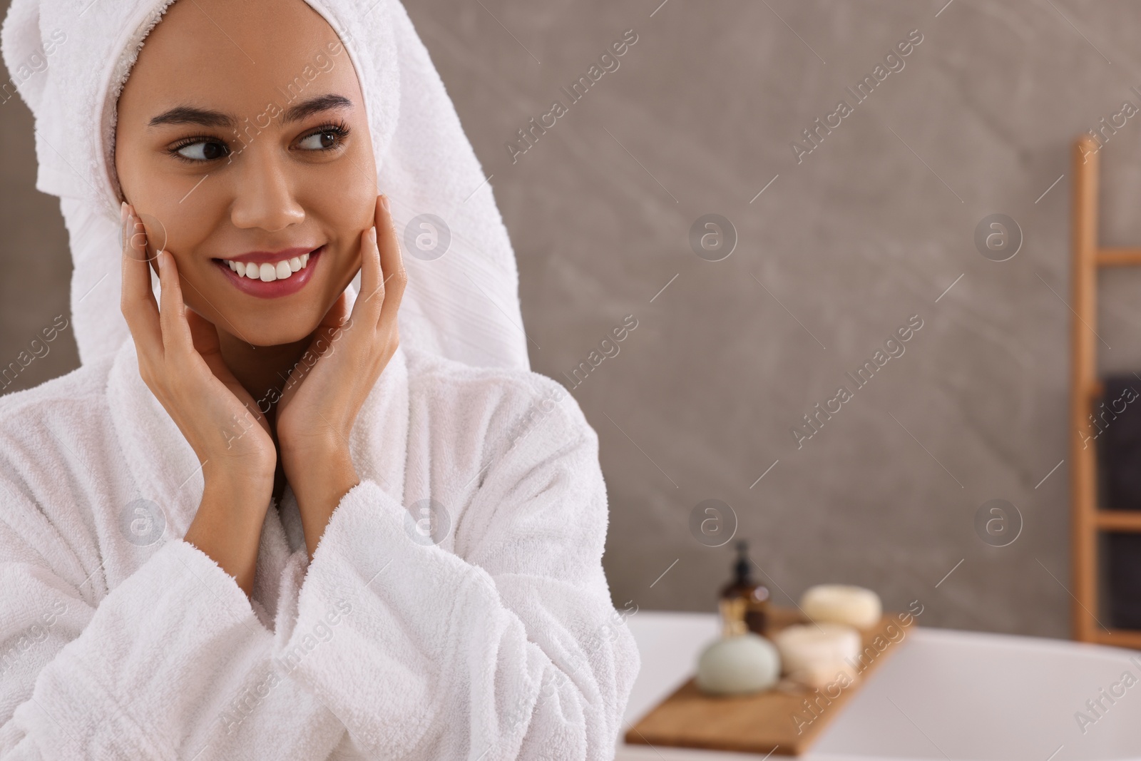 Photo of Beautiful African American woman in bathroom, space for text