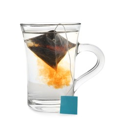 Photo of Tea bag in glass cup of hot water isolated on white