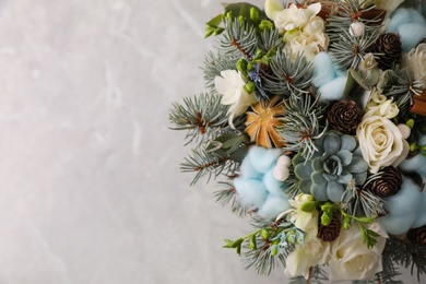 Beautiful wedding winter bouquet on grey table, top view. Space for text