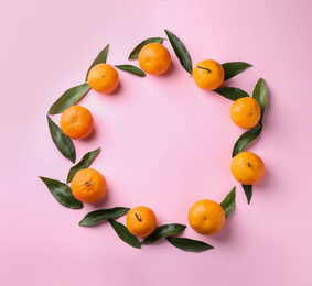Photo of Fresh ripe tangerines on pink background, flat lay. Space for text