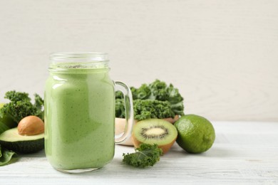 Photo of Tasty fresh kale smoothie on white wooden table