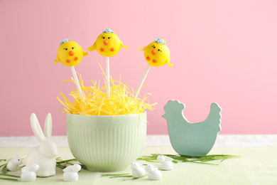 Photo of Delicious sweet cake pops and decor on table. Easter holiday