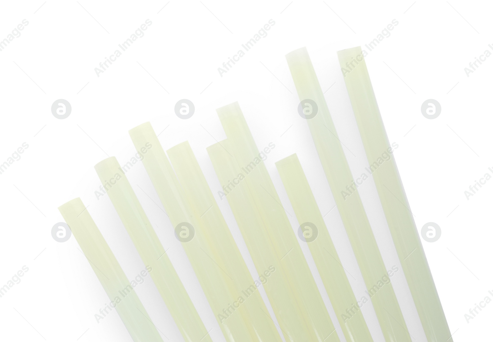 Photo of Many glue sticks for gun on white background, top view