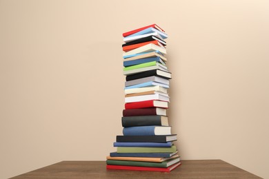 Photo of Stack of hardcover books on beige background