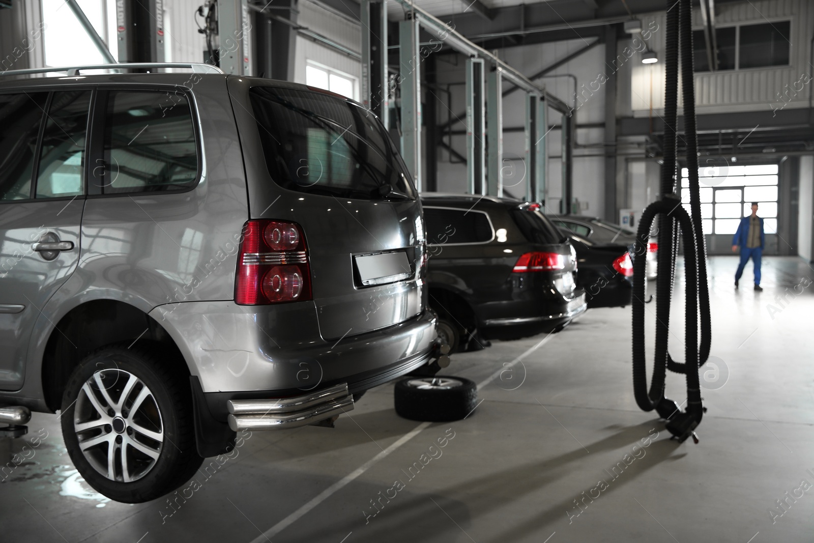 Photo of View of modern automobile repair shop with cars
