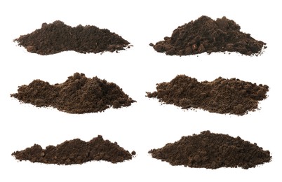 Set with piles of fertile soil on white background