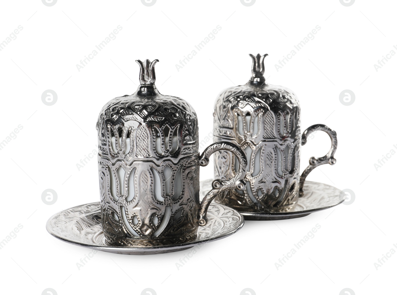 Photo of Beautiful vintage cup holders and saucers on white background