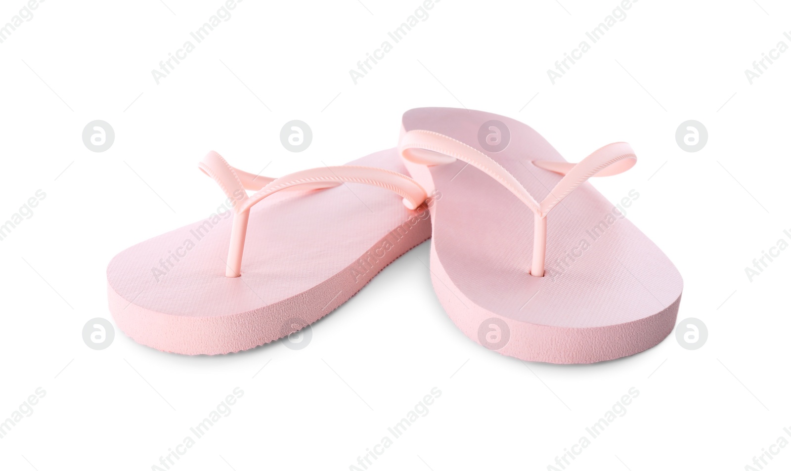 Photo of Light pink flip flops isolated on white. Beach accessory